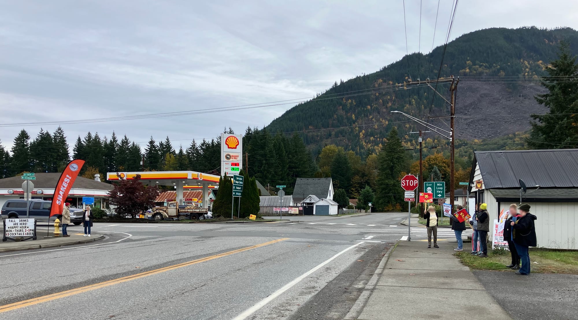 Darrington, WA small group of people at a crossroads with signs for No Kings protest, 10/18/25.